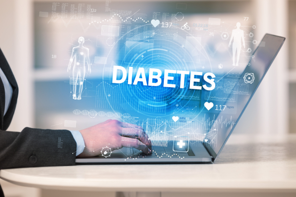  Side view of a woman working in a health check department recording medical test results in a laptop with "DIABETES" inscription, and virtual images of related icons shown above it.
