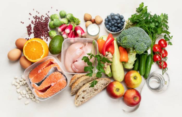 Top view of  balanced diet food arranged on a white table.