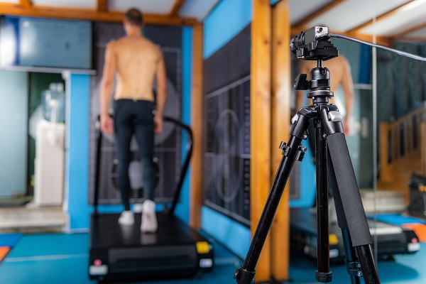 A man participating in a walking test as part of a biometric screening in a corporate health program.
