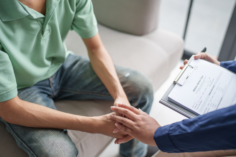 Psychologist supporting a patient in discussing mental health issues during therapy to enhance their quality of life.