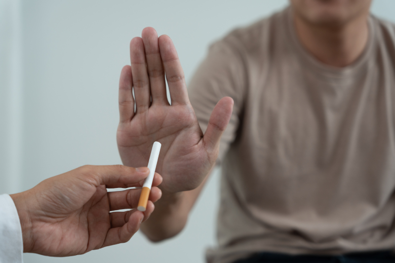 A person saying no to smoking, emphasizing a healthy lifestyle with good sleep, nutrition, and physical activity.