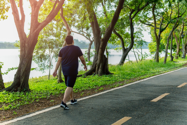 A man at risk of heart disease is walking to burn fat and reduce bad cholesterol.