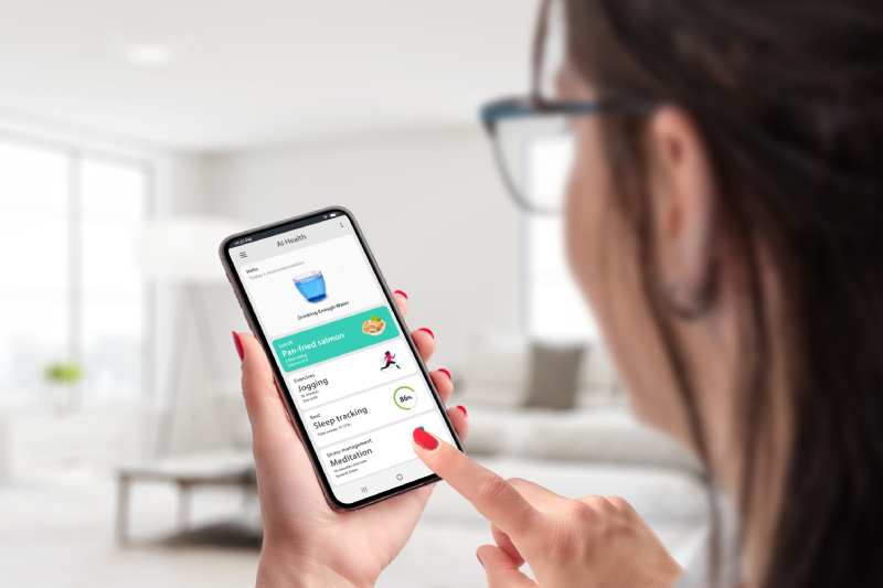 A woman holding a smartphone with the health app, using AI to track nutrition and exercise for health management.