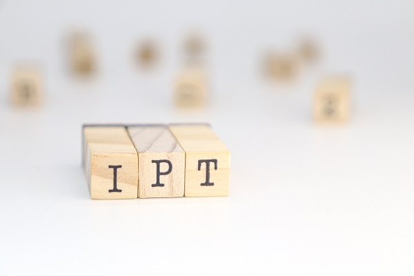 Wooden blocks spelling 'IPT' on a blurred background, representing IPT’s role in enhancing relationships and reducing stress.