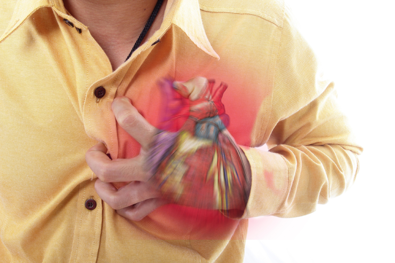 A man clutching his chest in pain with vibrant motion effects, symbolizing heart issues.