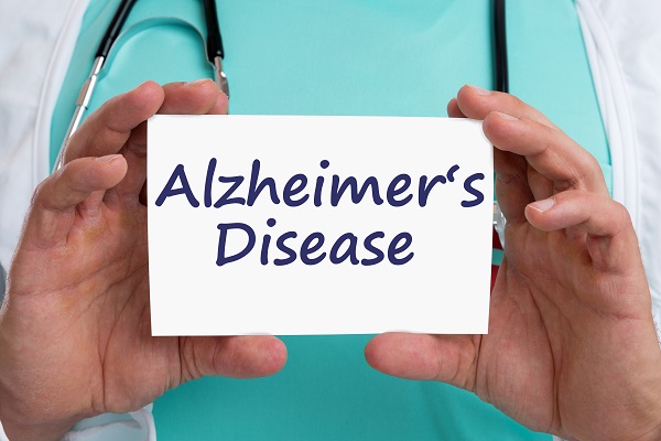 A doctor holding a sign that reads 'Alzheimer's Disease', a condition affecting memory, thinking, and behavior.