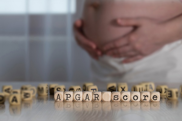 'APGAR' spelled out using wooden blocks, representing the newborn assessment conducted shortly after birth.