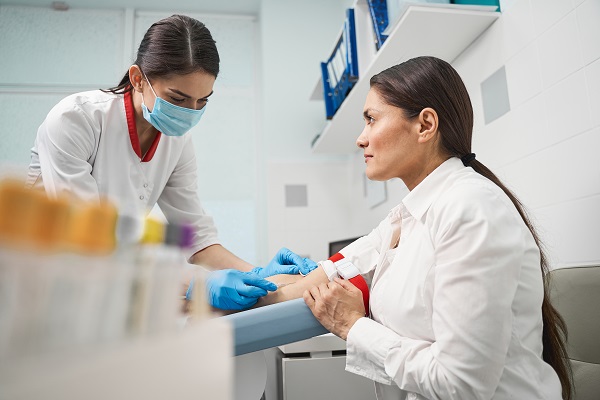 A medical professional taking a blood test from a patient, highlighting the importance of staying calm during the procedure.