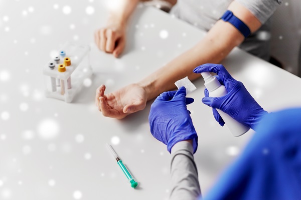 Healthcare professional sterilizing a patient's arm before administering an injection for an allergy test.