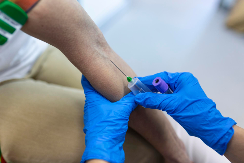 Healthcare professional drawing a blood sample from a patient to assess their overall health and monitor medical conditions.