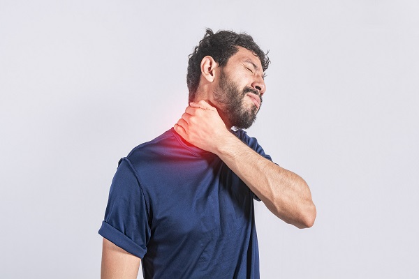 A man holding his neck in pain, representing paresthesia caused by severe nerve damage.